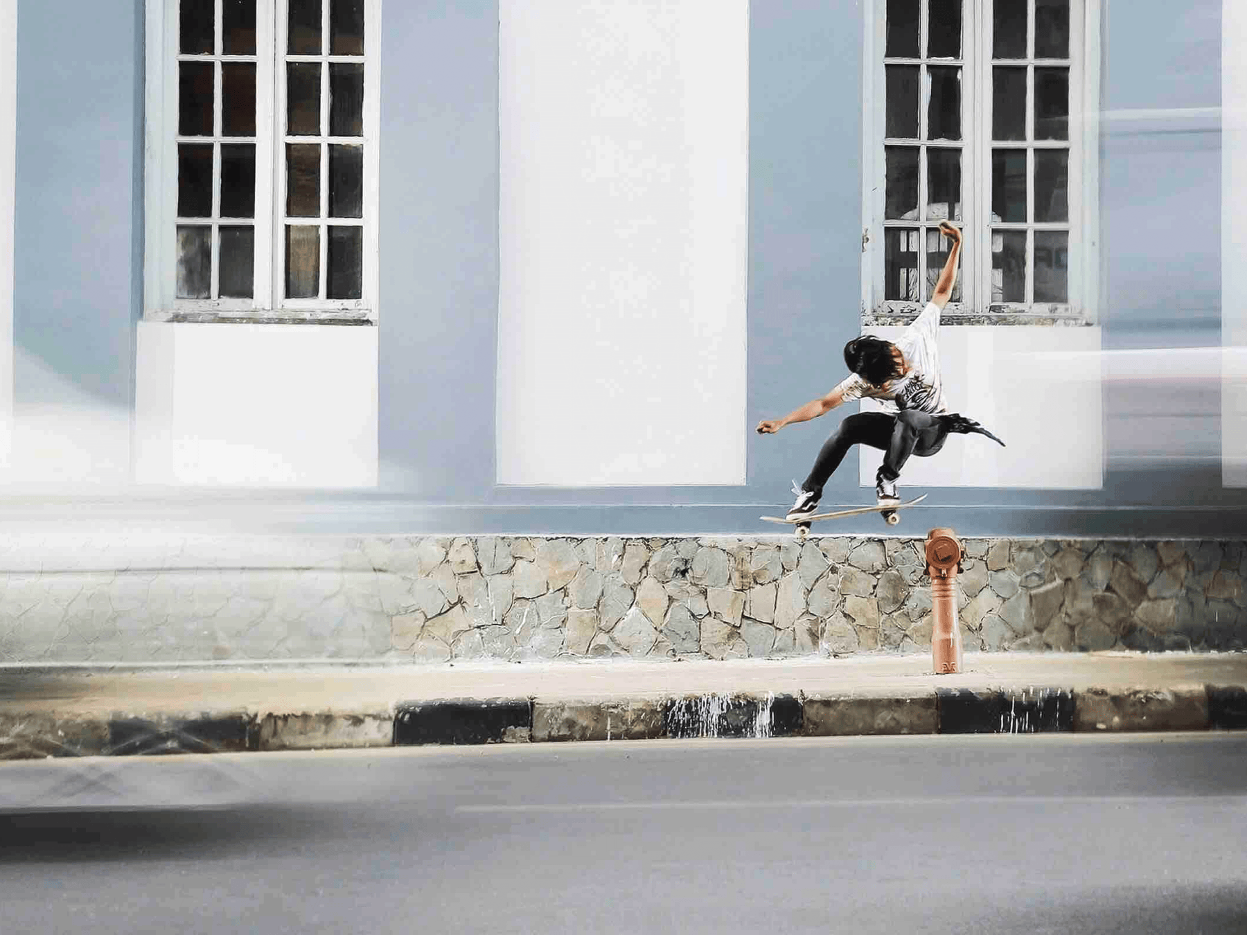 a skateboarder on a quiet street
